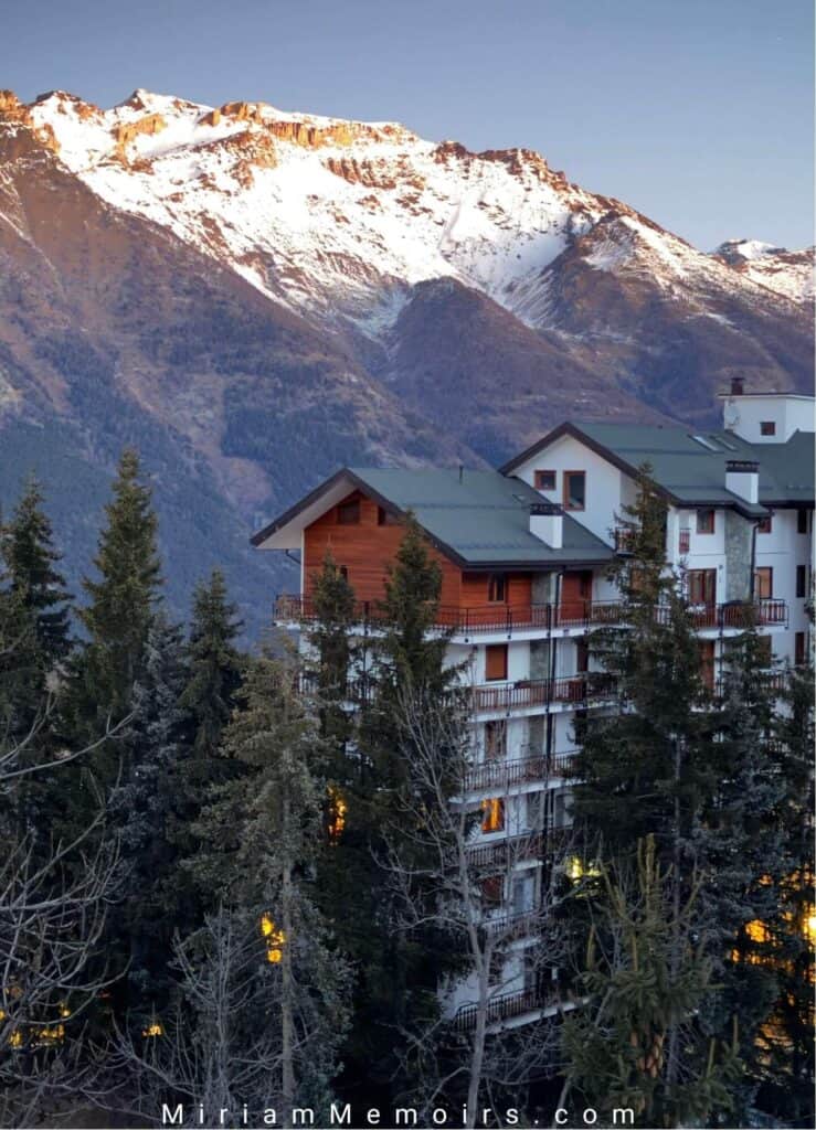 View from an apartment in Sauze d'Oulx, Italy - Mountain back drop with snow and chalet apartment in wood finishing. Alpine style. 